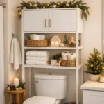 Closed over-the-toilet cabinet protecting towels from toilet plume in a small holiday guest bathroom
